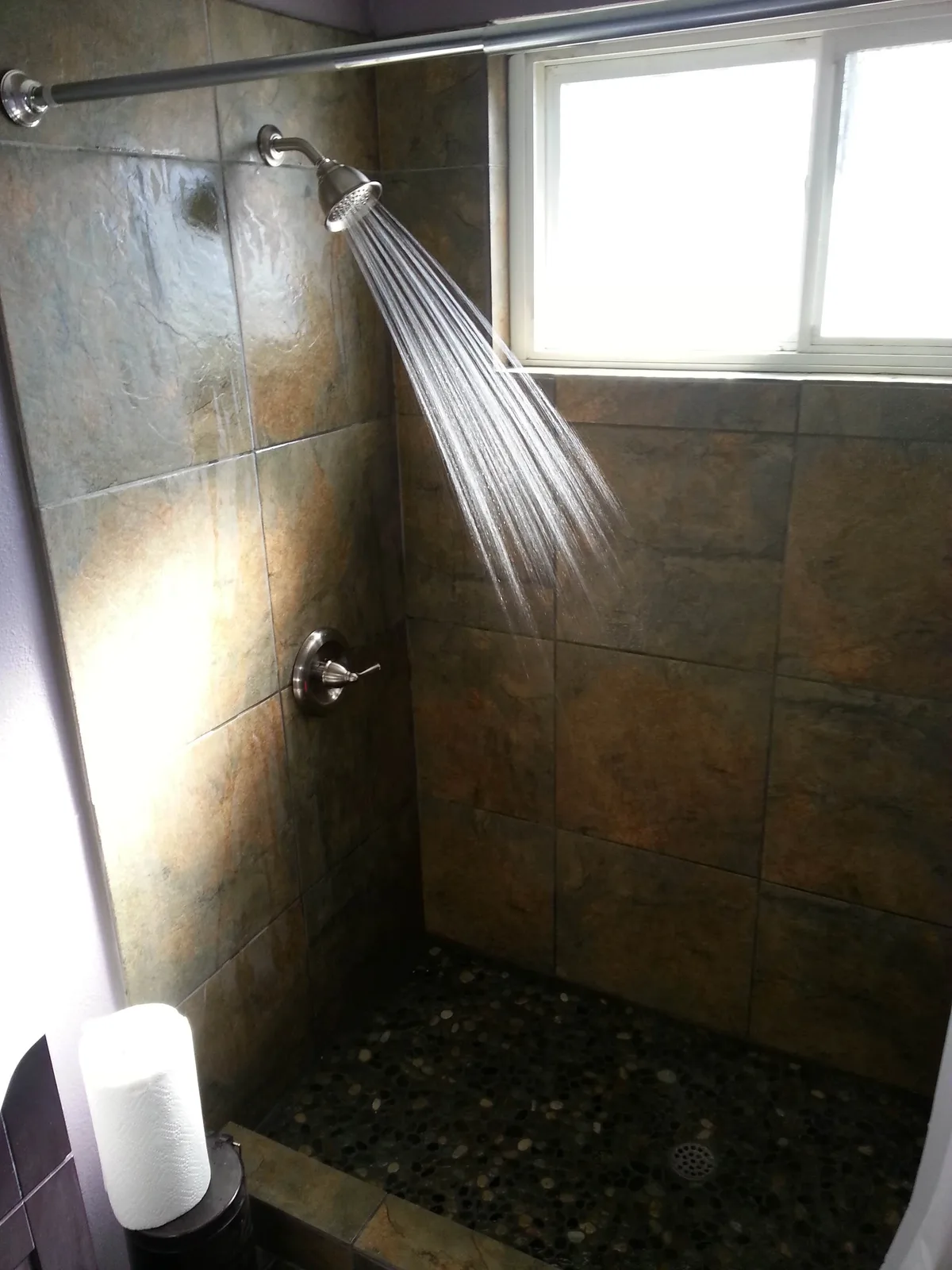A tiled shower running hot.
